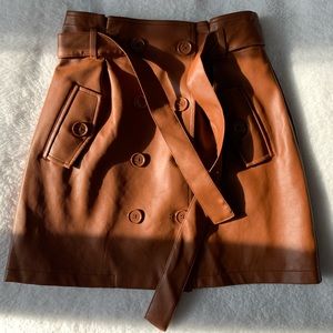 A faux lether skirt with a removable belt.